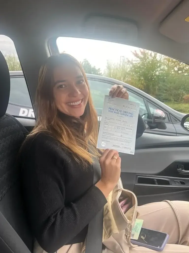 Andrea Panza, holding her practical driving test pass certificate