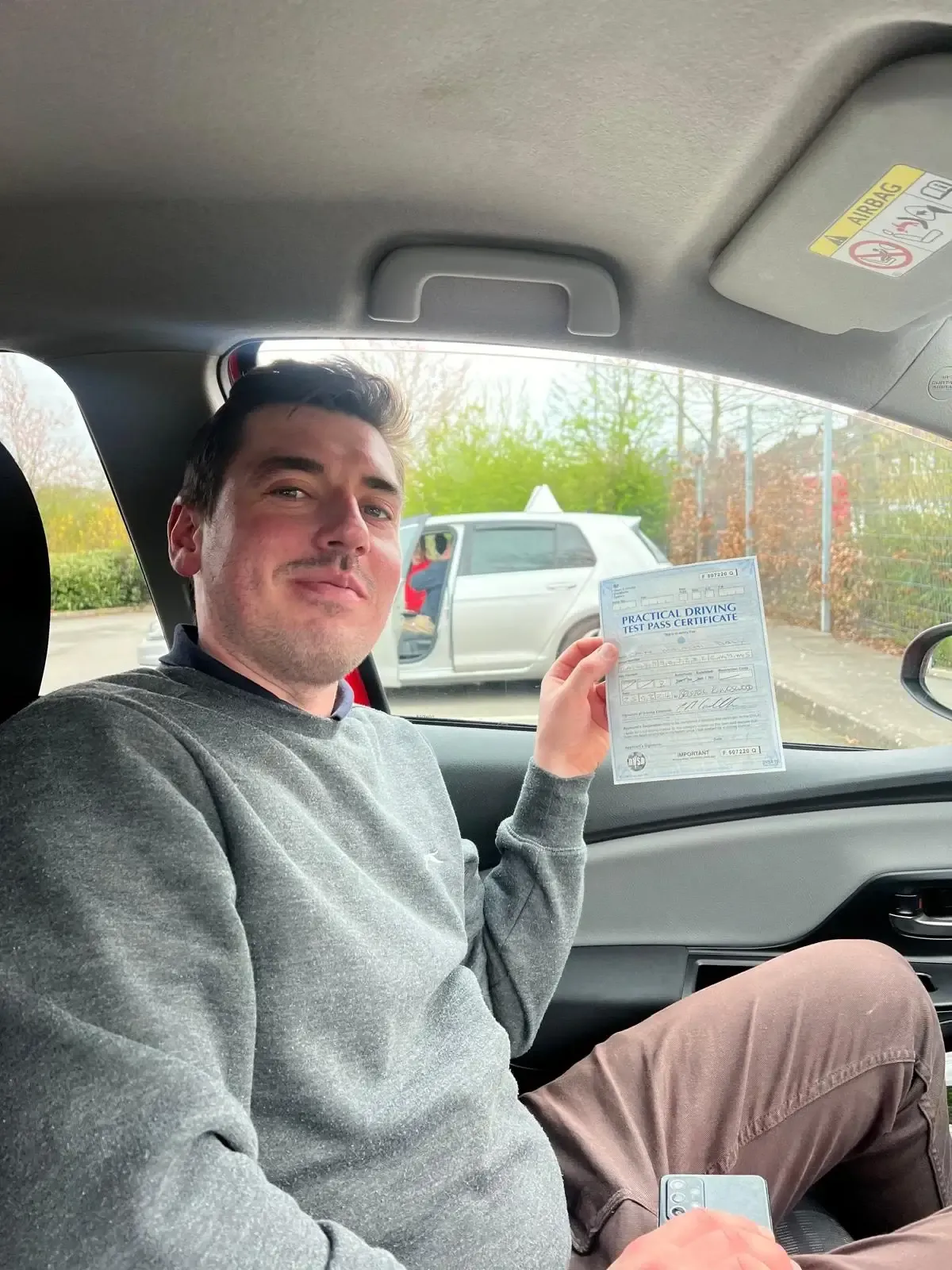 Cain Daly, holding his practical driving test pass certificate