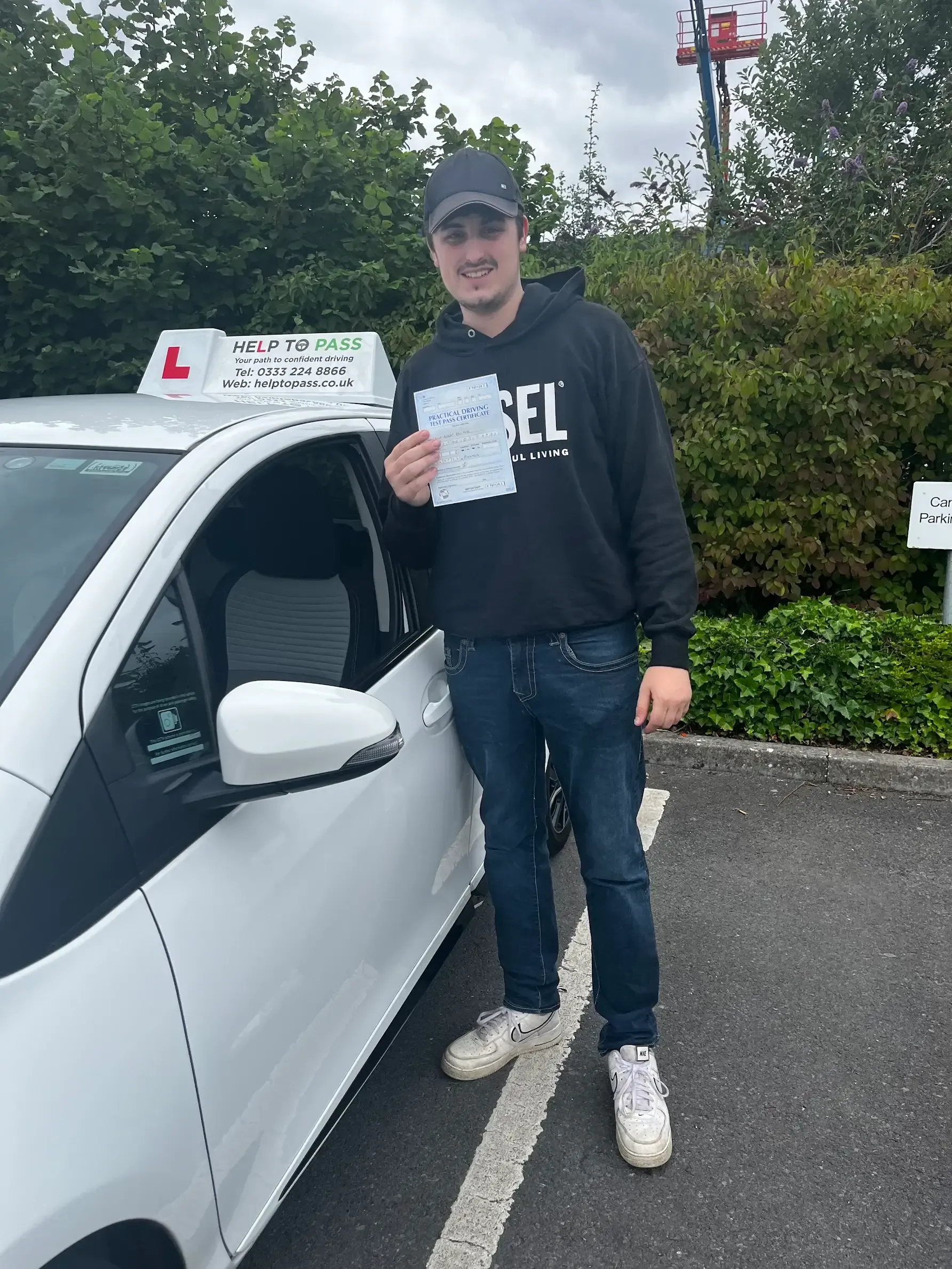 Calum Moss, holding his practical driving test pass certificate