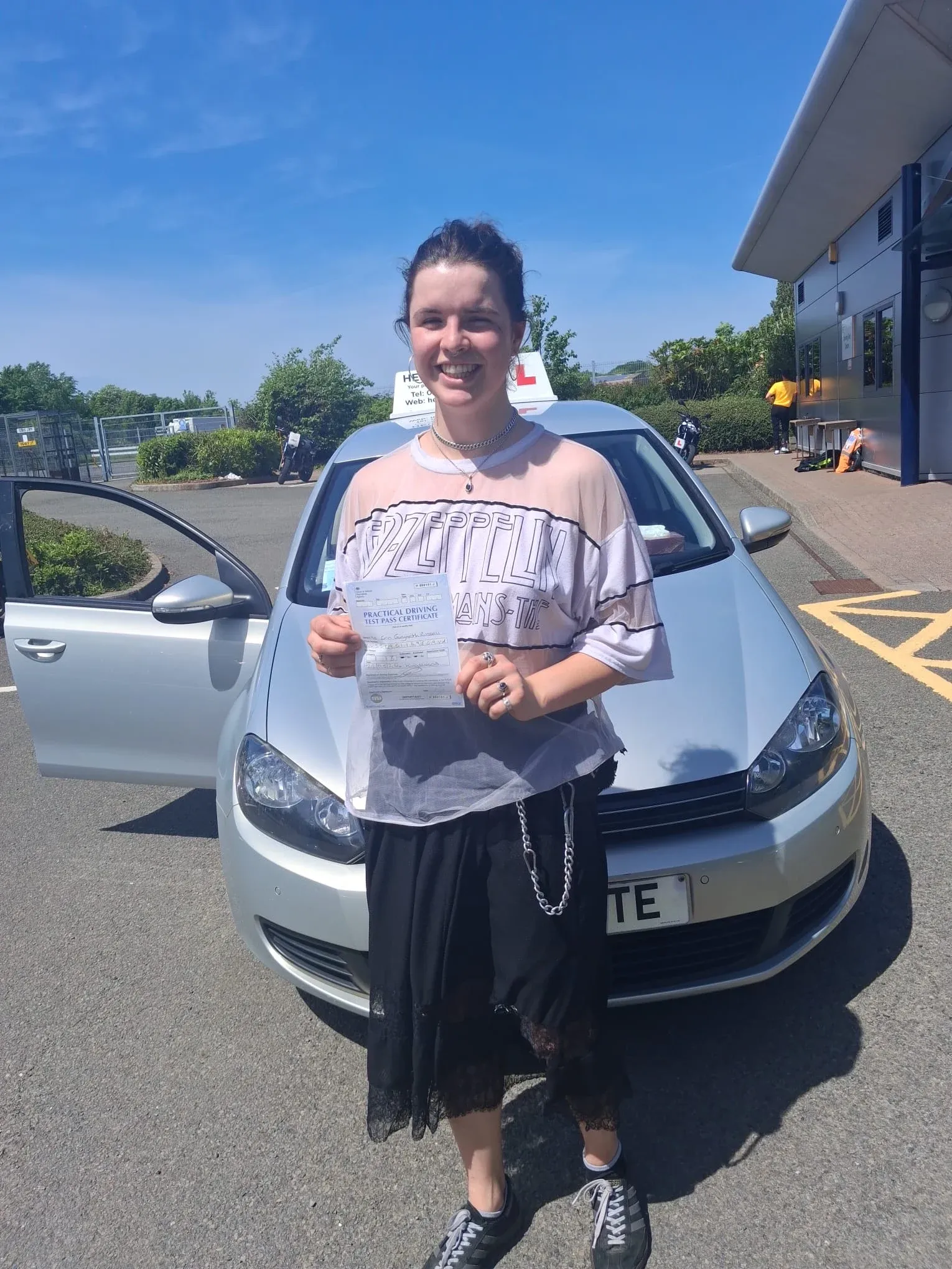 Erin Russel, holding her practical driving test pass certificate