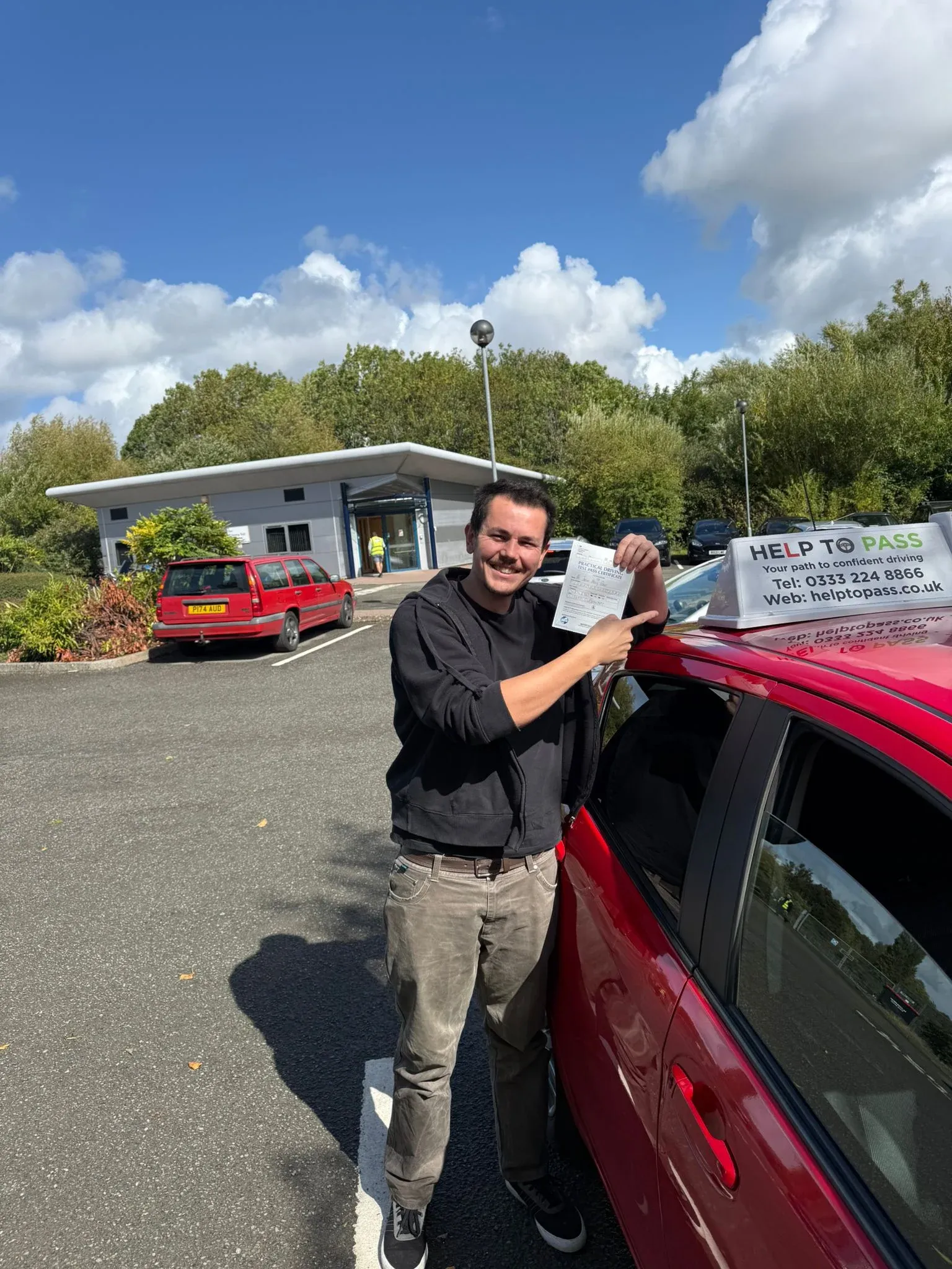 James Flower, holding his practical driving test pass certificate