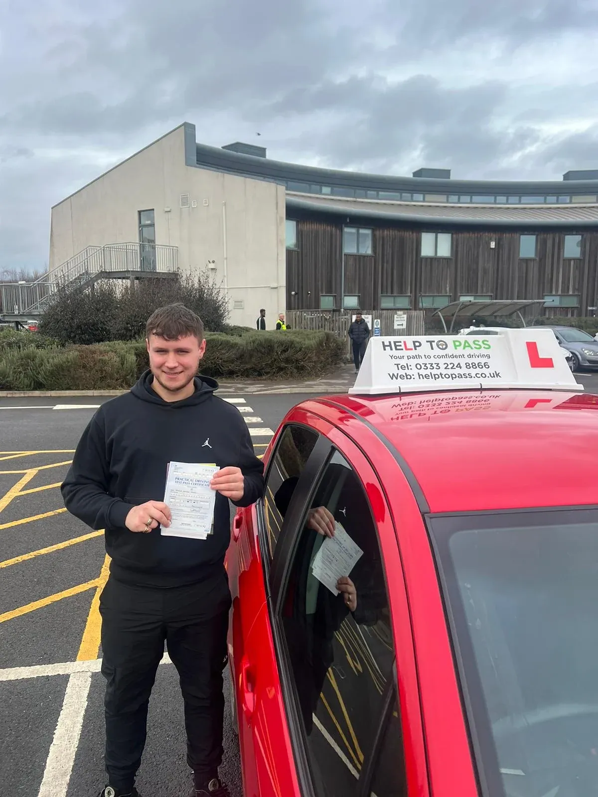 Josh James, holding his practical driving test pass certificate