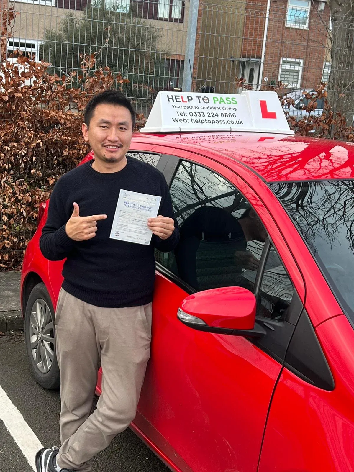 Kinley Gyeltshen, holding his practical driving test pass certificate