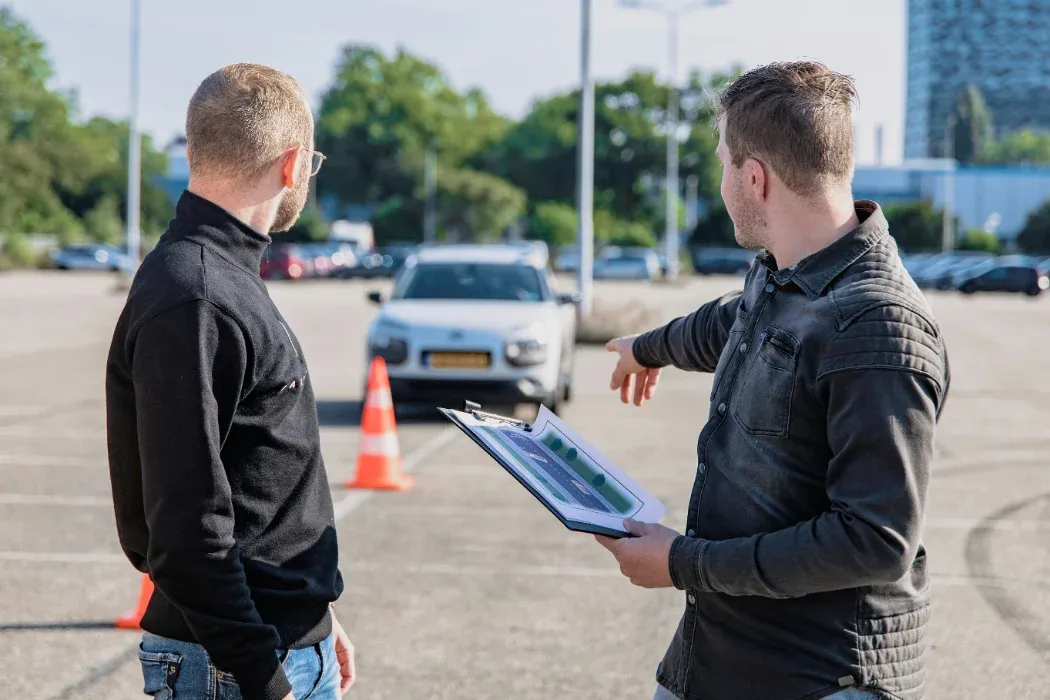 An instructor talking a learner through a manoeuvre in a car park