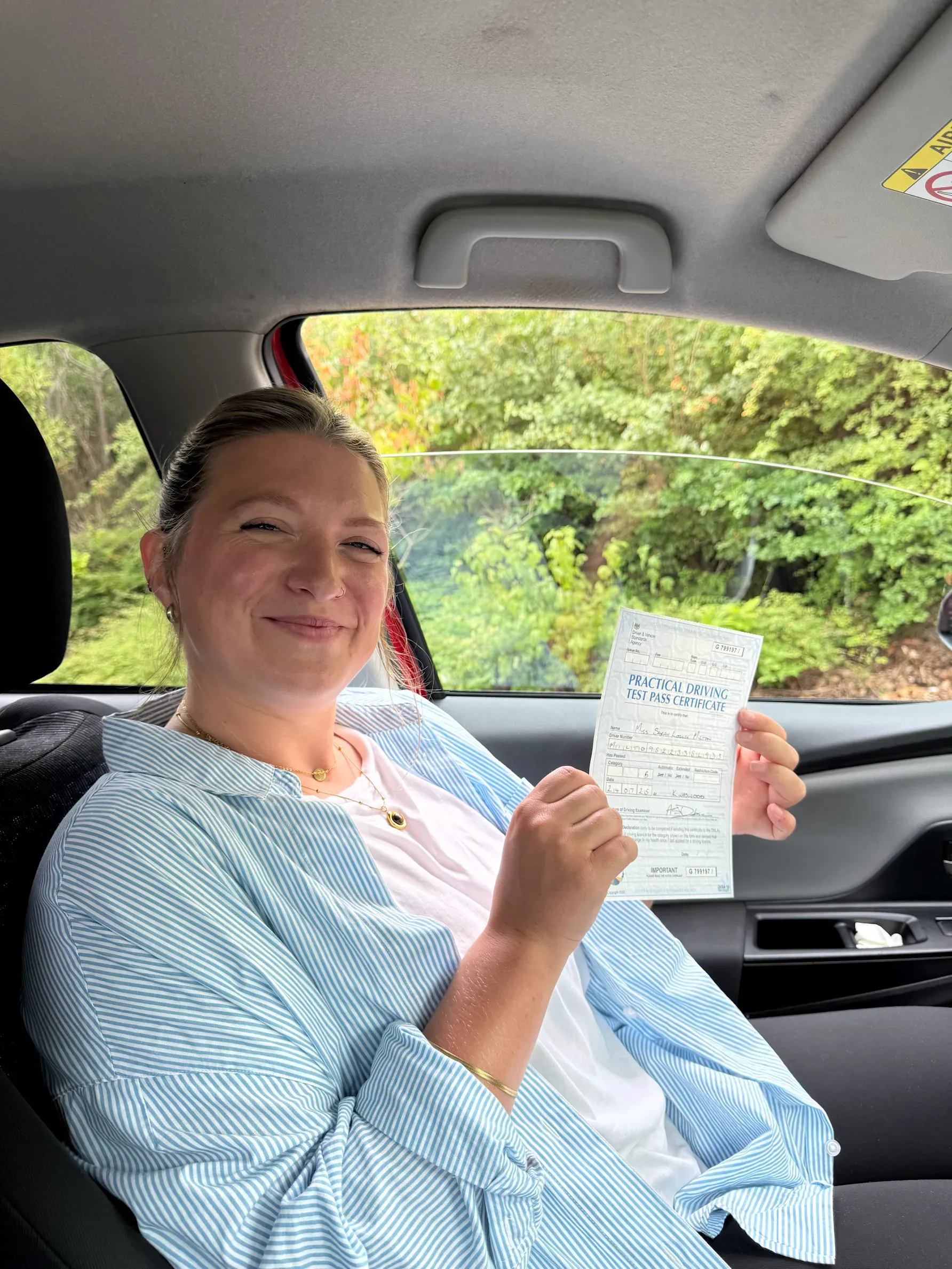 Sarah Milton, holding her practical driving test pass certificate