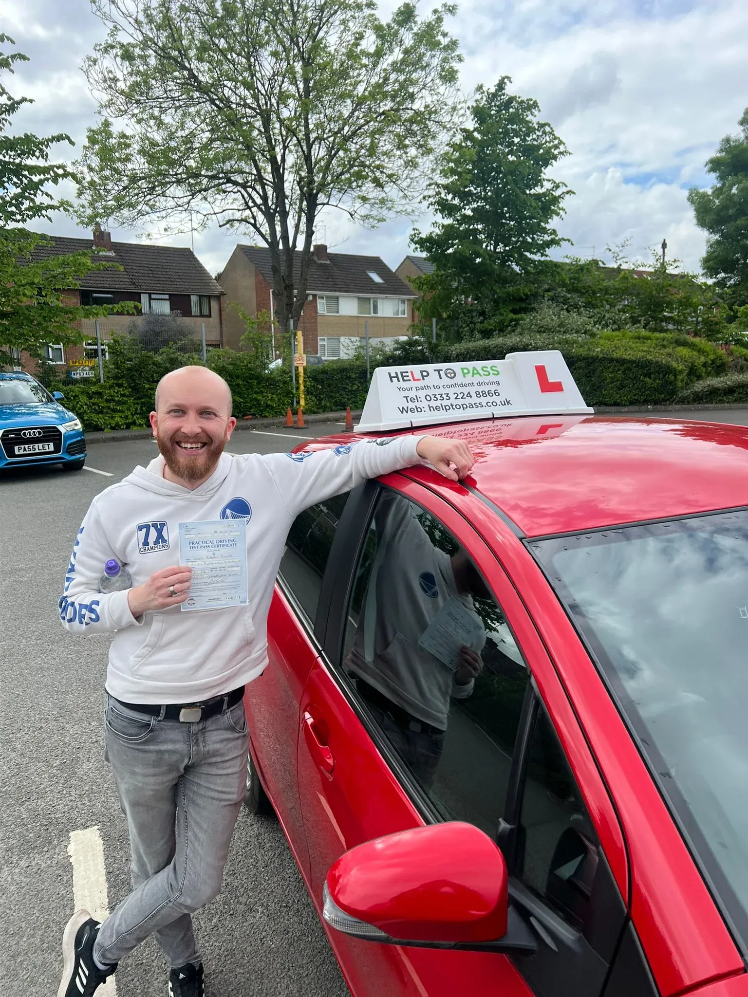 Scott Phillips, holding his practical driving test pass certificate