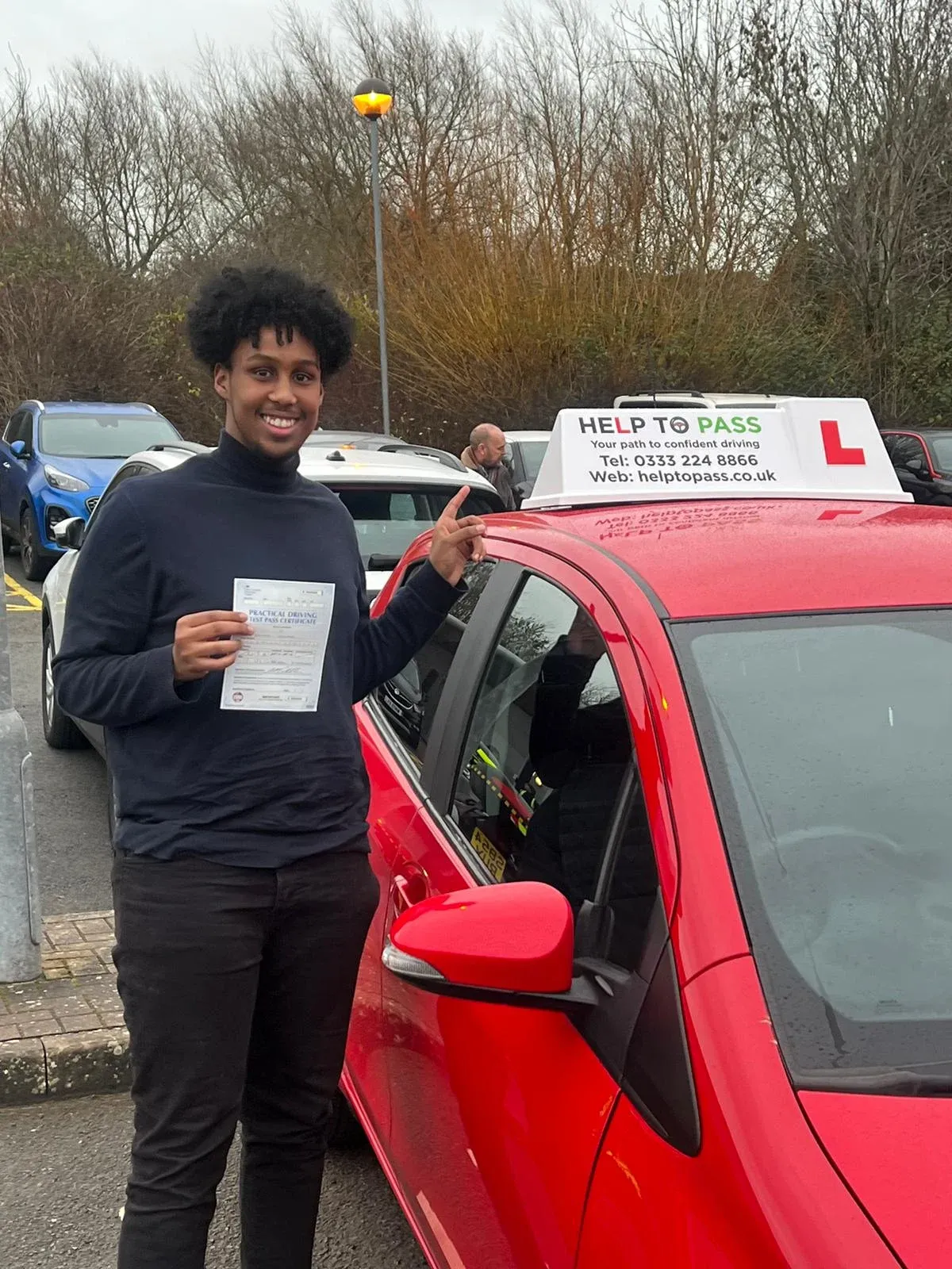 YG Hanad, holding his practical driving test pass certificate